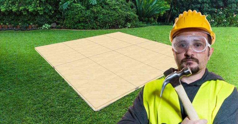 DIY man building a dance floor on grass from plywood